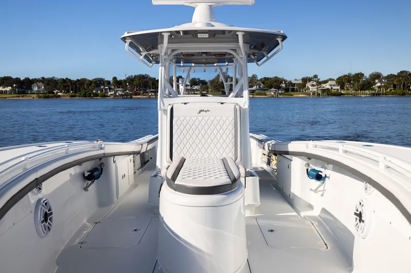 Bid Time 2 Yacht Photos Pics 2023 Yellowfin 36 Offshore boat on calm water, showcasing sleek design and spacious deck.