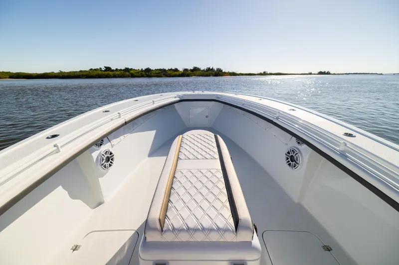 Bid Time 2 Yacht Photos Pics 2023 Yellowfin 36 Offshore boat interior with cushioned seating, on calm water.