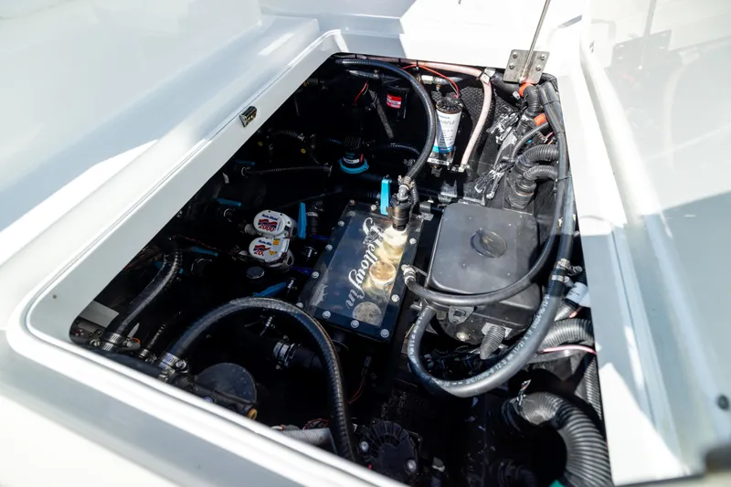 Bid Time 2 Yacht Photos Pics Engine compartment of 2023 Yellowfin 36 Offshore boat, showcasing intricate wiring and components.