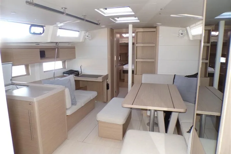 Skyfall Yacht Photos Pics Interior of 2025 Beneteau Oceanis 46.1 yacht, featuring modern dining area and light wood finishes.