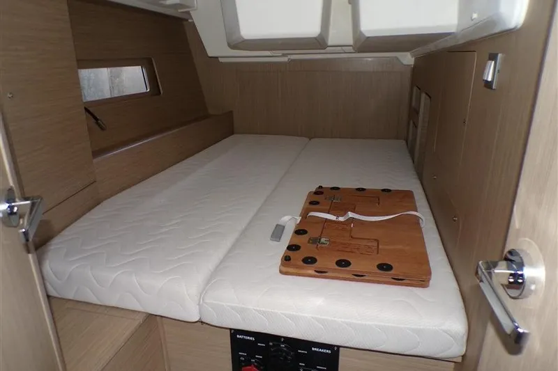 Skyfall Yacht Photos Pics Interior cabin of 2025 Beneteau Oceanis 46.1 yacht with bed and wooden panel.