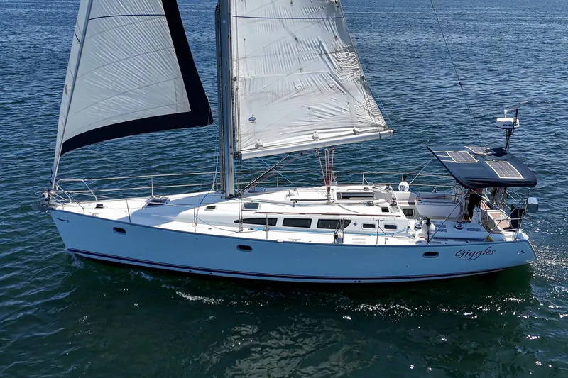  Yacht Photos Pics 2002 Jeanneau Sun Odyssey 43 sailboat cruising on open water.