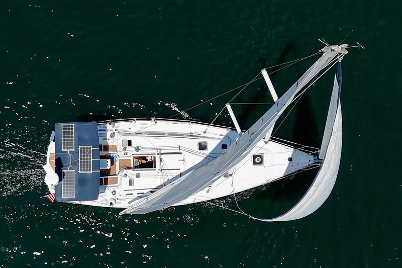  Yacht Photos Pics Aerial view of 2002 Jeanneau Sun Odyssey 43 sailing yacht on open water.