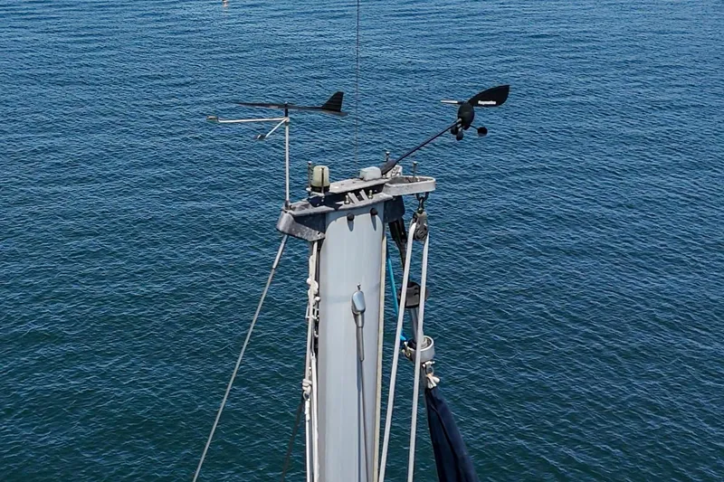  Yacht Photos Pics Mast of 2002 Jeanneau Sun Odyssey 43 sailboat against blue ocean background.