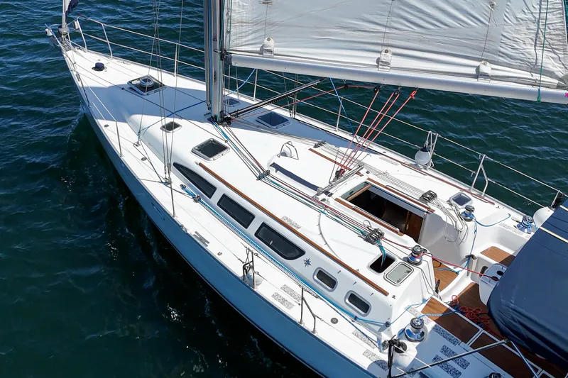  Yacht Photos Pics Jeanneau Sun Odyssey 43 sailboat from 2002 on open water, showcasing sleek design and sails.