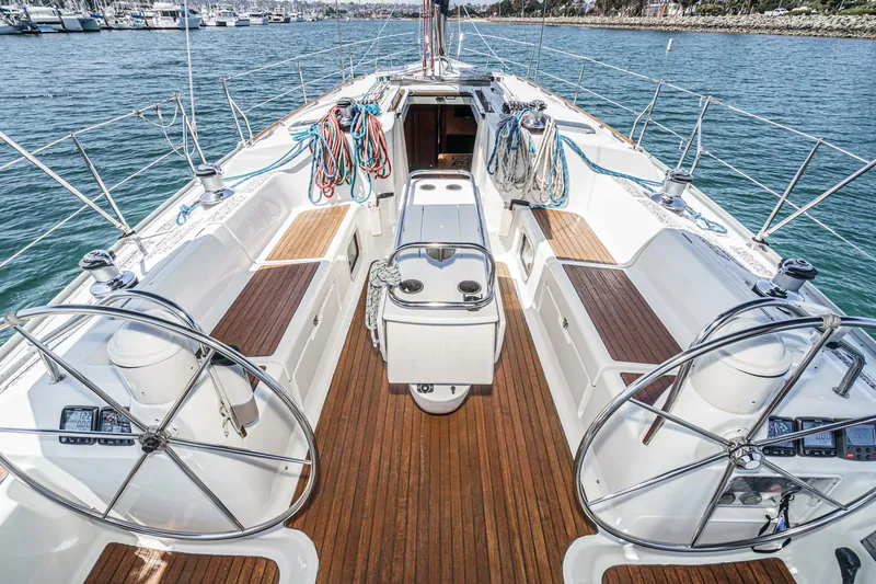  Yacht Photos Pics Jeanneau Sun Odyssey 43 sailboat cockpit, 2002 model, with dual steering wheels and teak decking.