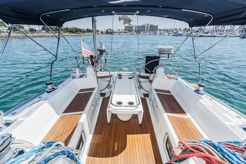 Yacht Photos Pics Jeanneau Sun Odyssey 43 sailboat cockpit, 2002 model, with teak flooring and marina view.
