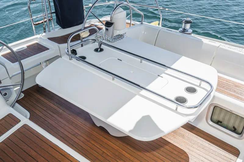  Yacht Photos Pics Cockpit of 2002 Jeanneau Sun Odyssey 43 sailboat with wooden deck and steering wheel.