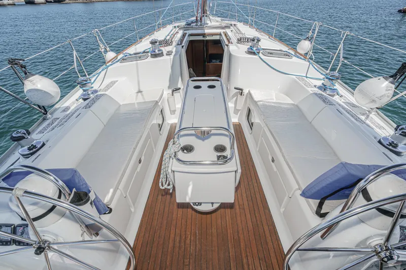  Yacht Photos Pics 2002 Jeanneau Sun Odyssey 43 sailboat cockpit with teak flooring and seating, docked at marina.