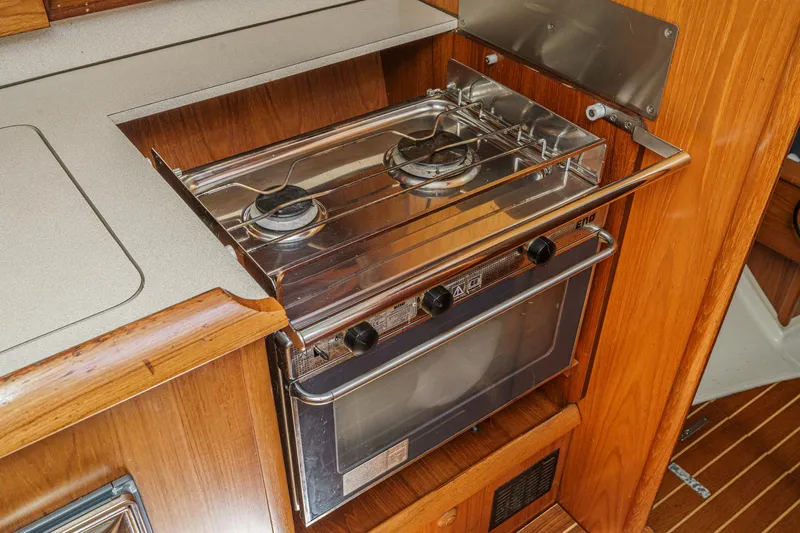  Yacht Photos Pics Galley kitchen in 2002 Jeanneau Sun Odyssey 43 sailboat with stove and oven.