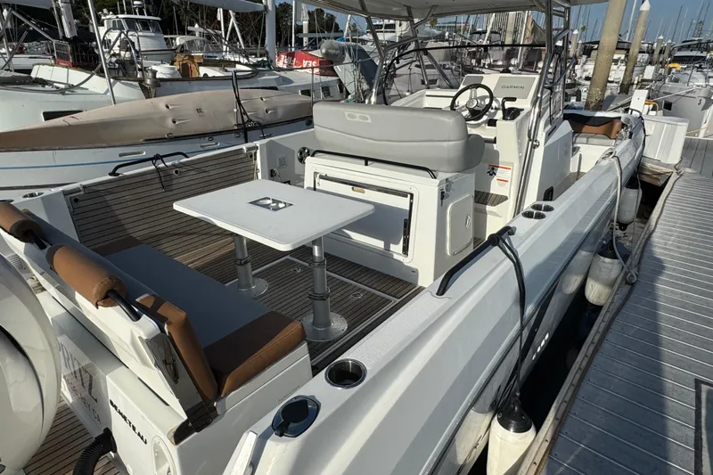 Spritz Yacht Photos Pics 2022 Beneteau Flyer 9 SPACEdeck boat docked, featuring spacious seating and modern design.