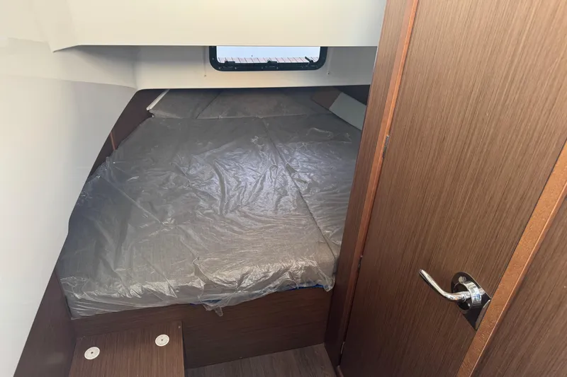 Spritz Yacht Photos Pics 2022 Beneteau Flyer 9 SPACEdeck cabin interior with bed and wooden finish.