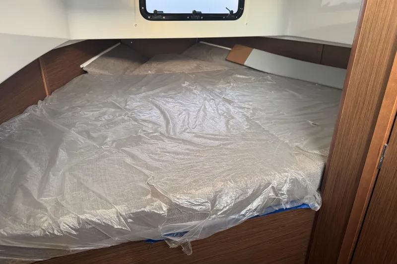 Spritz Yacht Photos Pics Interior cabin of 2022 Beneteau Flyer 9 SPACEdeck with plastic-covered bed.