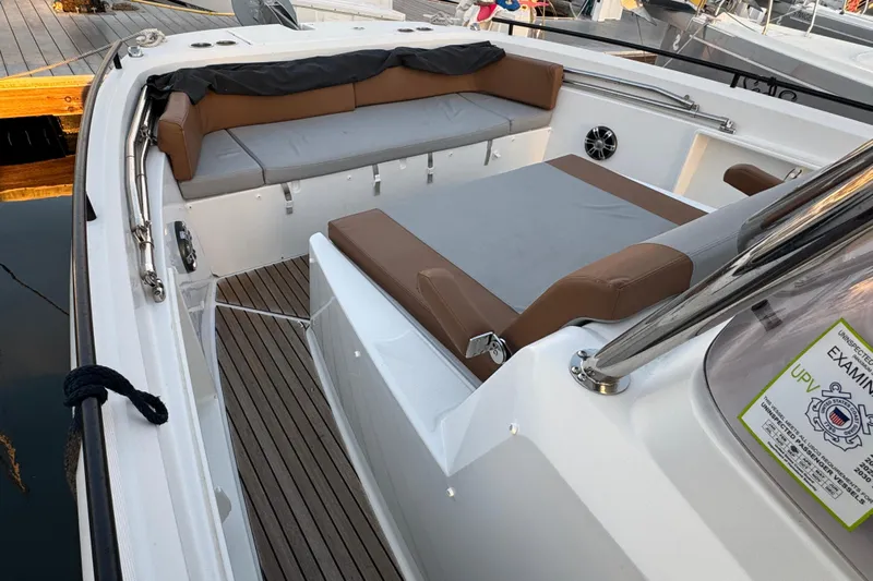 Spritz Yacht Photos Pics 2022 Beneteau Flyer 9 SPACEdeck interior with cushioned seating and wooden flooring.