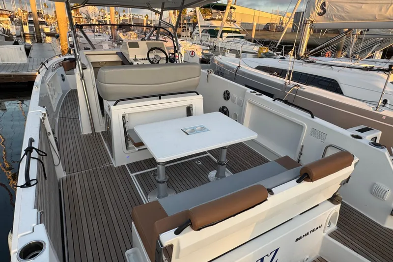 Spritz Yacht Photos Pics 2022 Beneteau Flyer 9 SPACEdeck boat interior with seating and table at marina.
