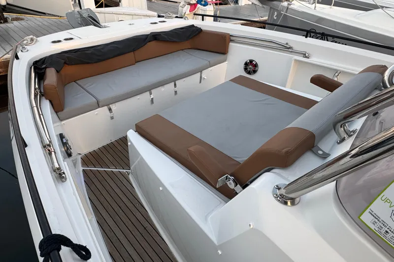 Spritz Yacht Photos Pics 2022 Beneteau Flyer 9 SPACEdeck interior with cushioned seating and wooden flooring.