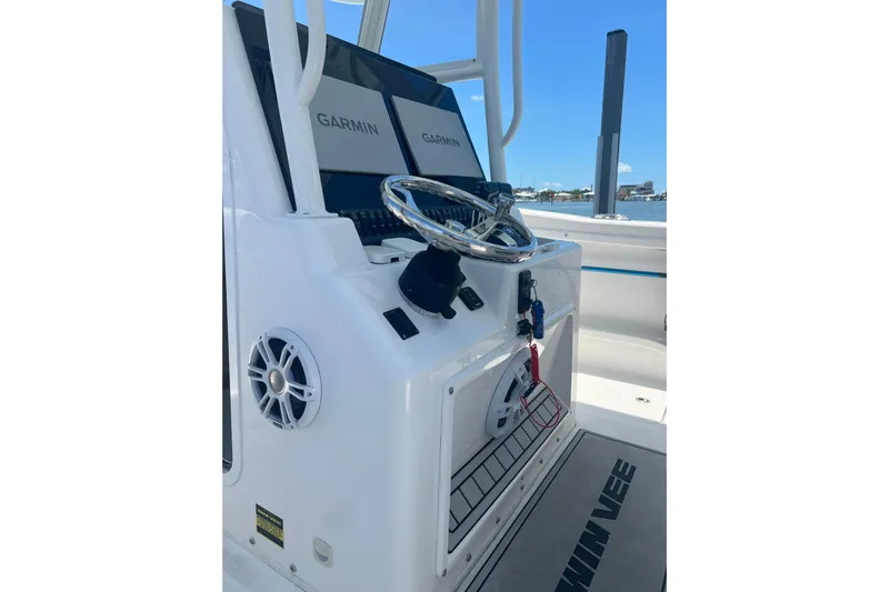  Yacht Photos Pics 2022 Twin Vee 280 GFX CC boat console with Garmin displays and steering wheel.