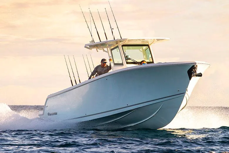  Yacht Photos Pics Manufacturer Provided Image: 2026 Sailfish 312 CC boat cruising on open water at sunset.