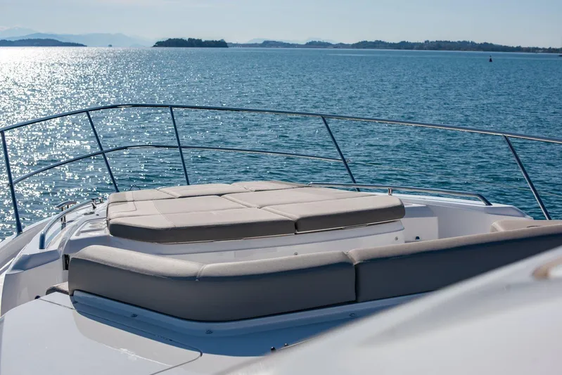 M/y Far Away Yacht Photos Pics Luxurious 2019 Princess S65 yacht deck with sunbeds overlooking serene ocean waters.