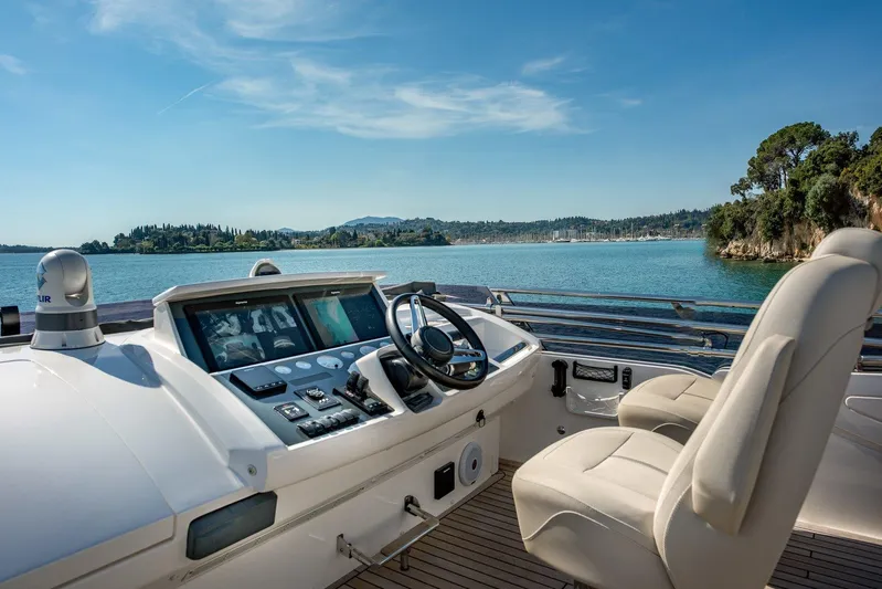 M/y Far Away Yacht Photos Pics Helm of 2019 Princess S65 yacht with scenic ocean view and modern controls.