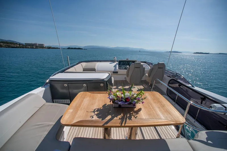 M/y Far Away Yacht Photos Pics Luxurious 2019 Princess S65 yacht deck with seating, table, and ocean view.