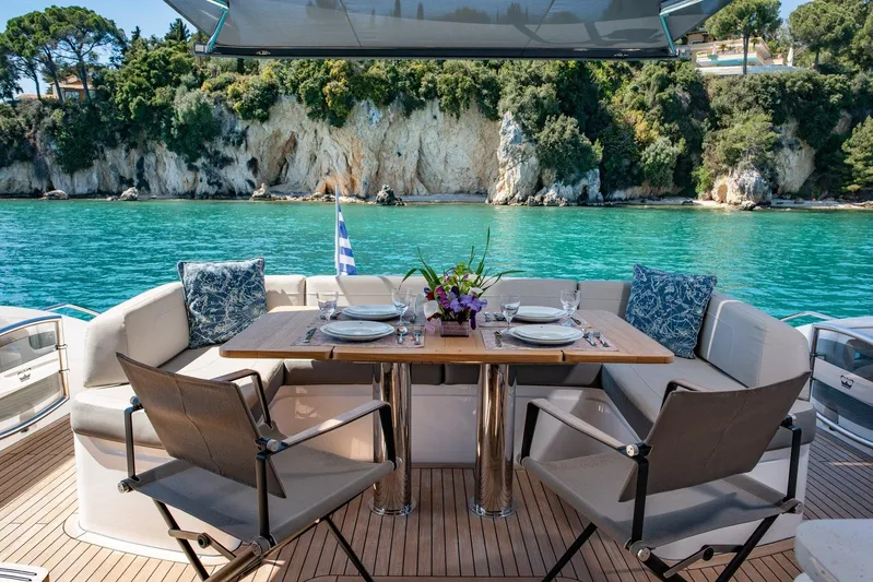 M/y Far Away Yacht Photos Pics Luxurious 2019 Princess S65 yacht dining area with scenic ocean view and elegant table setting.