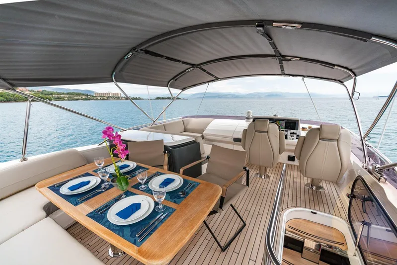 M/y Far Away Yacht Photos Pics Luxurious 2019 Princess S65 yacht deck with dining setup and ocean view.