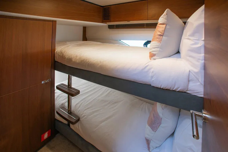 M/y Far Away Yacht Photos Pics Bunk beds in 2019 Princess S65 yacht cabin with wooden interior.