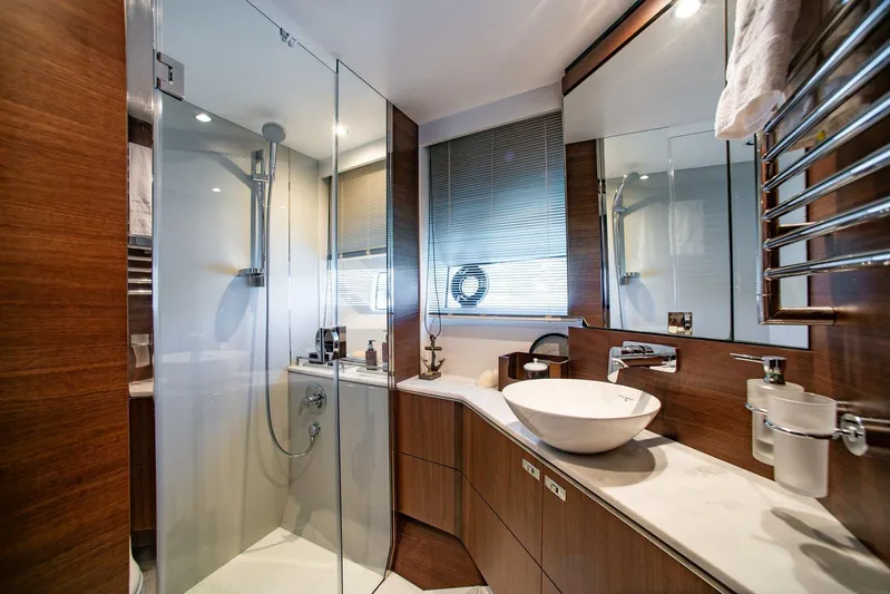 M/y Far Away Yacht Photos Pics Luxurious bathroom in 2019 Princess S65 yacht with modern fixtures and wooden accents.