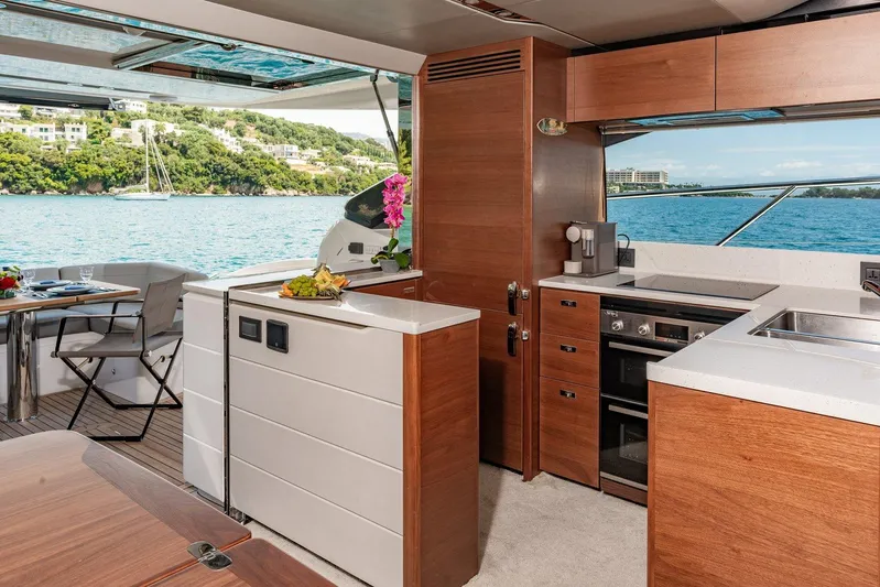 M/y Far Away Yacht Photos Pics Luxurious 2019 Princess S65 yacht interior with modern kitchen and scenic ocean view.