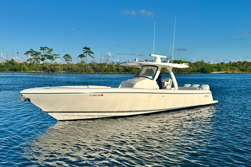  Yacht Photos Pics 2020 Intrepid 375 Nomad SE boat on calm water under clear blue sky.