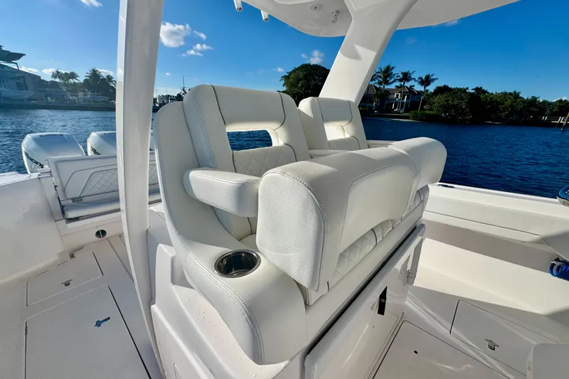  Yacht Photos Pics 2020 Intrepid 375 Nomad SE boat with luxurious white seating and scenic waterfront view.