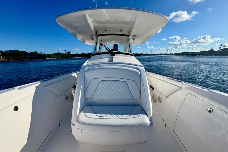  Yacht Photos Pics 2020 Intrepid 375 Nomad SE boat on calm water under clear blue sky.
