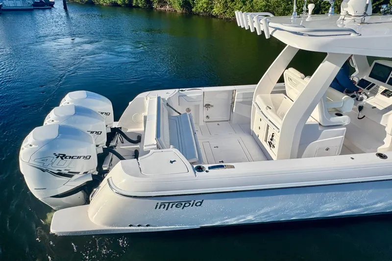  Yacht Photos Pics 2020 Intrepid 375 Nomad SE boat with triple outboard engines on calm water.