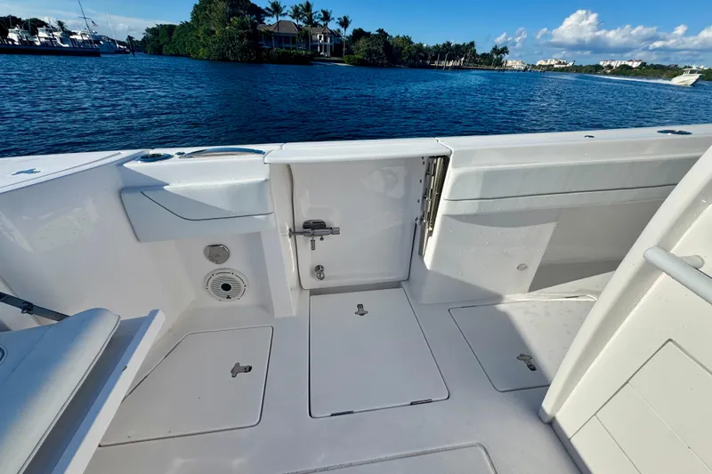  Yacht Photos Pics 2020 Intrepid 375 Nomad SE boat deck with open hatch, near scenic waterfront.