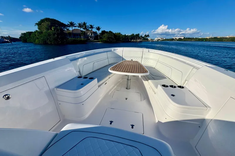  Yacht Photos Pics 2020 Intrepid 375 Nomad SE boat interior with seating and table on a sunny day.