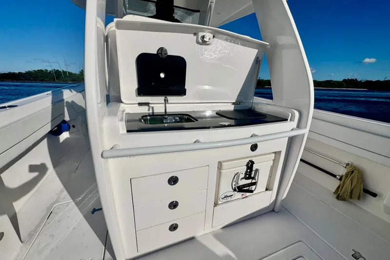  Yacht Photos Pics 2020 Intrepid 375 Nomad SE boat interior with sink and storage, ocean view.