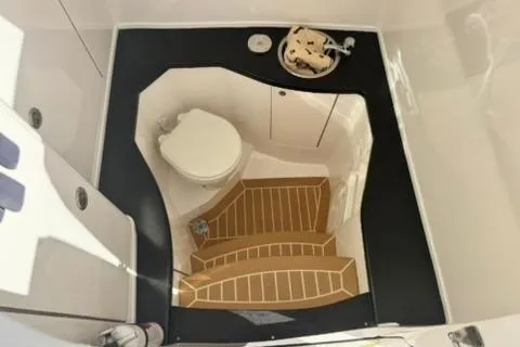  Yacht Photos Pics 2020 Intrepid 375 Nomad SE boat bathroom with toilet and wooden flooring.