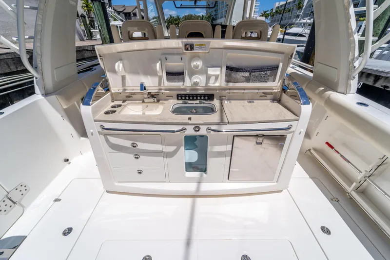  Yacht Photos Pics 2017 Boston Whaler 420 Outrage boat interior with kitchenette and seating area.