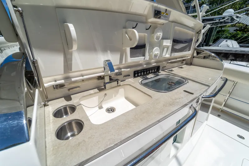  Yacht Photos Pics 2017 Boston Whaler 420 Outrage boat kitchen area with sink and storage.
