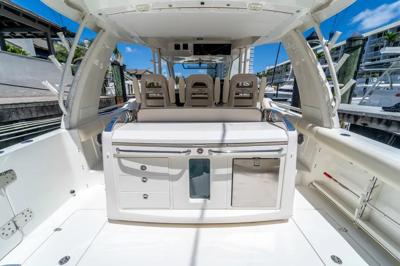  Yacht Photos Pics 2017 Boston Whaler 420 Outrage boat interior with seating and storage, docked under clear skies.