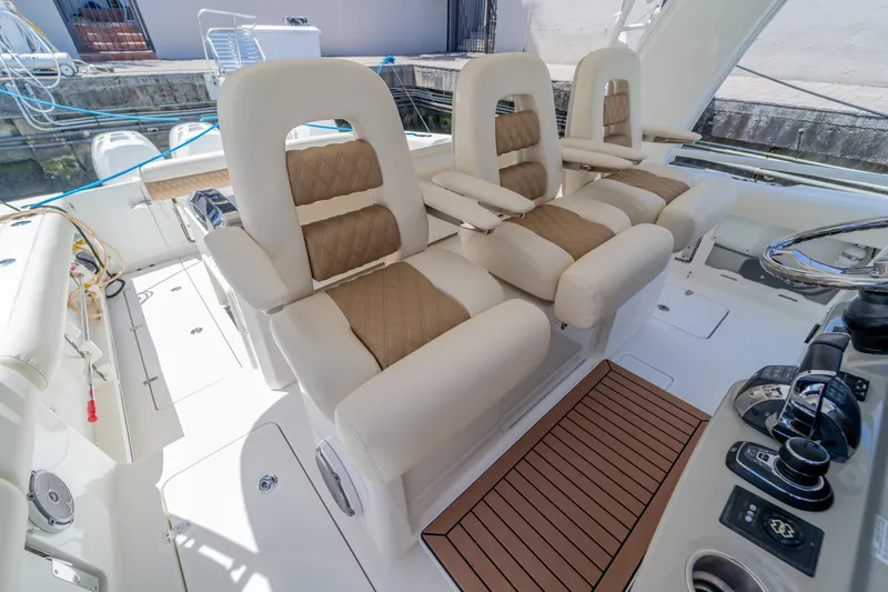  Yacht Photos Pics Luxurious seating on a 2017 Boston Whaler 420 Outrage boat, featuring plush, tan upholstery.