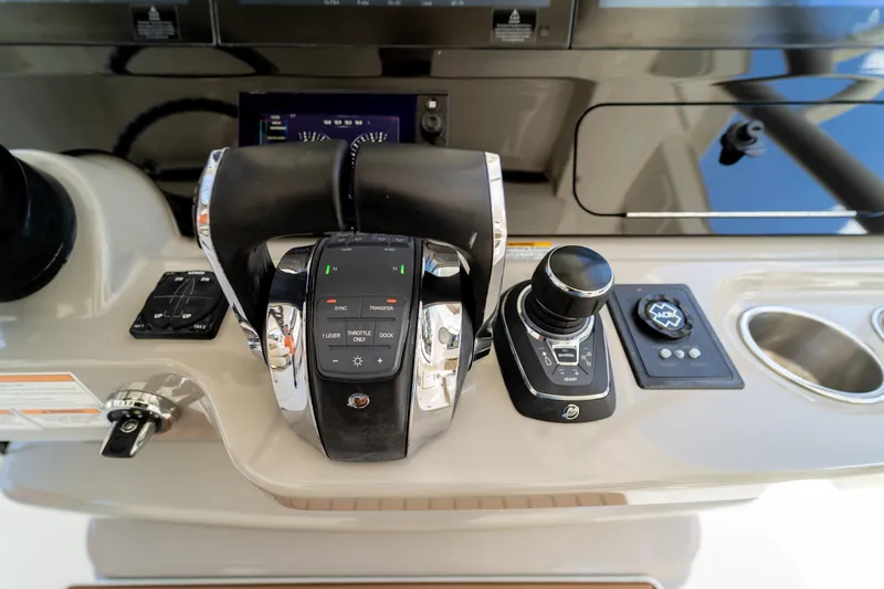  Yacht Photos Pics Control panel of a 2017 Boston Whaler 420 Outrage boat, featuring throttle and joystick.