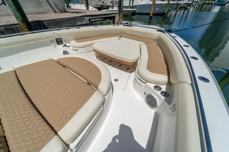  Yacht Photos Pics 2017 Boston Whaler 420 Outrage boat interior with cushioned seating and table.