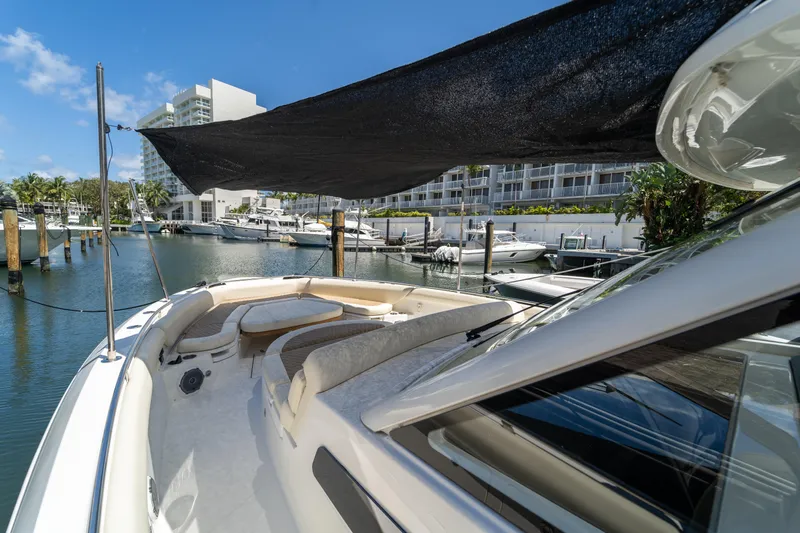  Yacht Photos Pics 2017 Boston Whaler 420 Outrage docked in a marina, featuring a shaded deck area.