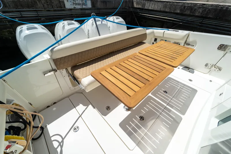  Yacht Photos Pics 2017 Boston Whaler 420 Outrage boat deck with seating and wooden table.