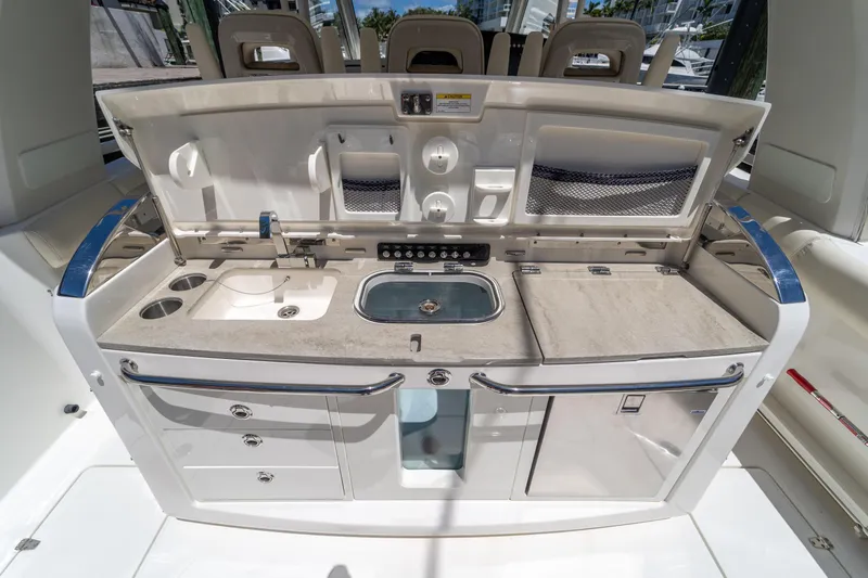  Yacht Photos Pics 2017 Boston Whaler 420 Outrage boat kitchen with sink, storage, and countertop.