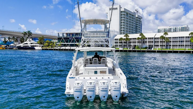  Yacht Photos Pics 2017 Boston Whaler 420 Outrage boat on water near cityscape and Hilton hotel.