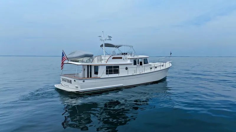 Dogfish Yacht Photos Pics 2023 Krogen Express 52 yacht cruising on calm blue waters.