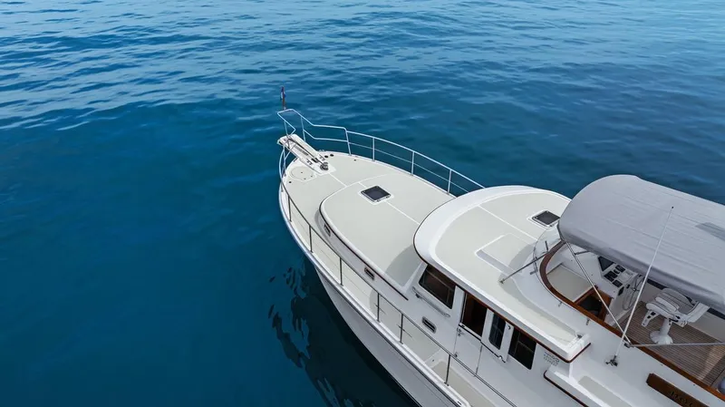 Dogfish Yacht Photos Pics 2023 Krogen Express 52 yacht cruising on calm blue waters.